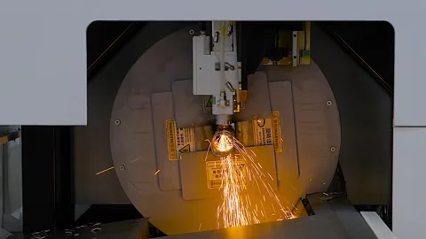 Laser cutting machine is operating on metal workpiece with sparks - slow motion Stock Footage 341323653