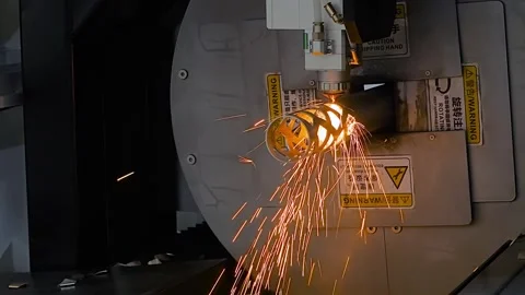Laser cutting machine is operating on metal workpiece with sparks - slow motion Stock Footage 344661801