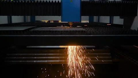 Laser cutting machine is operating on sheet metal with sparks - slow motion Stock Footage 344661838