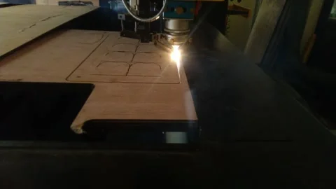 Laser cutting machine precisely engraving intricate patterns on wood surface. Stock Footage 339310661