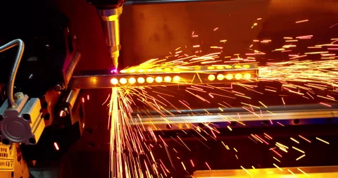 A laser cutting machine processing a metal profile with sparks flying. Stock Footage 336557269