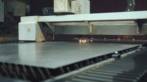 Laser cutting machine processing metal sheet in industrial workshop Stock Photos