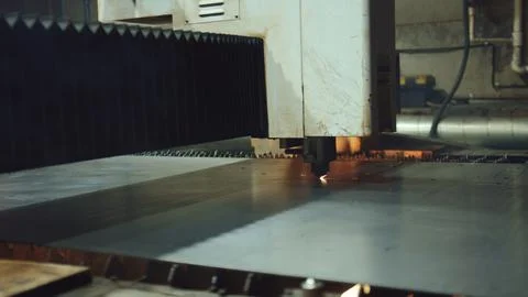 Laser cutting machine processing metal sheet in industrial factory Stock Photos
