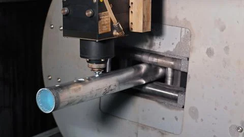 Laser cutting machine processing metal pipe. Close-up of an industrial laser Stock Photos