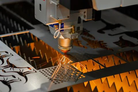 Laser cutting machine working with sheet metal with sparks Stock Photos