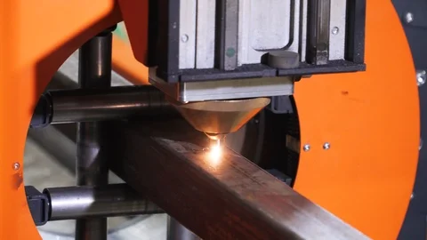 Laser cutting process, making a hole in metal tube. Industrial CNC machine Stock Footage 122812498