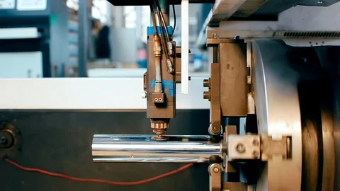 Laser cutting process, making a hole in metal tube. Modern industrial CNC Stock Footage 130064065