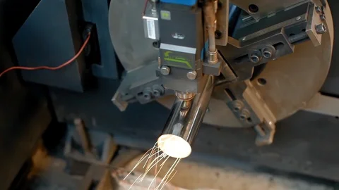 Laser cutting process, making a hole in metal tube. Modern industrial CNC Stock Footage 130064119