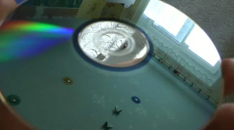 Laser disk DVD and nursery reflection with butterflies on a ceiling in it Stock Footage 11818422