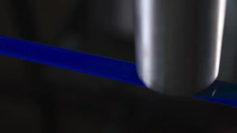 Laser engraves mark on blue wire, closeup Stock Footage 268826900
