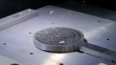 Laser engraving machine burns pattern on circular metal workpiece Stock Footage 278333333