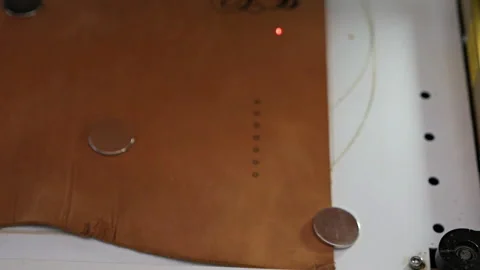 Laser engraving machine work,skin logo. Leather purse Stock Footage 125446475