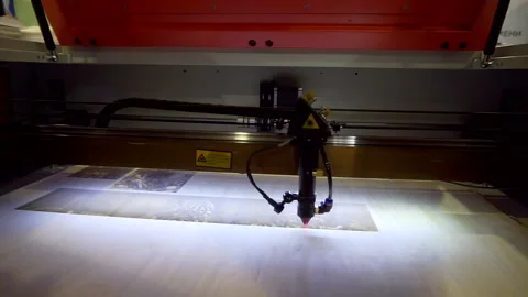 Laser engraving on wood. Laser printer moves on a wooden surface. 库存影片 141840242