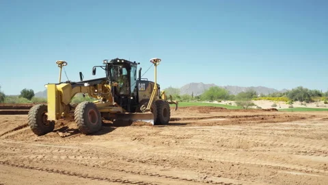 Laser guided Crawler Tractor shoveling dirt to grade the ground Stock Footage 217524625