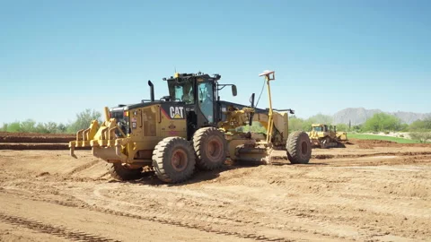 Laser guided Crawler Tractor shoveling dirt to grade the ground Stock Footage 217528763