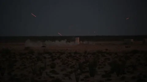 Laser from helicopter hitting target in desert at dusk  Vídeos de archivo 151251966