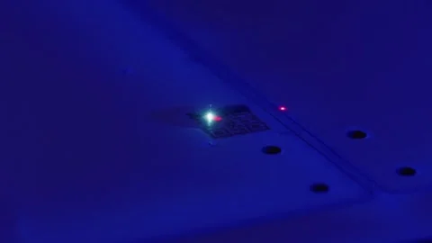 Laser illuminating microchip on printed circuit board in blue light Stock Footage 316540760