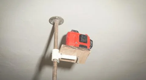 Laser level measuring tool at construction site. Stock Photos