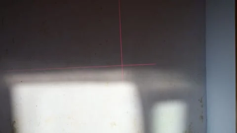 Laser level projecting red lines on wall under construction Stock-Footage 341362844