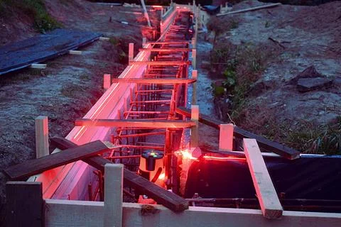 Laser level in a trench with formwork. Stock Photos