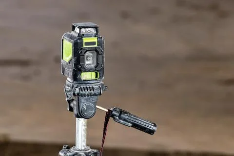 Laser level on a tripod at a construction site. Close-up. Taking measurements 스톡 사진