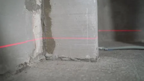 Laser level at work. Laser level and concrete walls and floor. Apartment reno Stock Photos