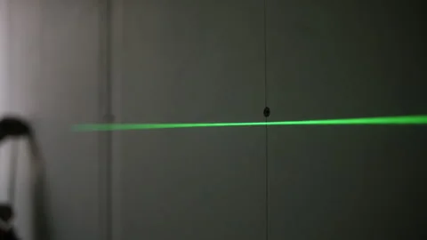 Laser line projected on drywall surface Stock Footage 314059088