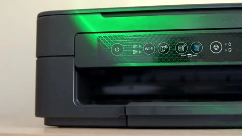 Laser printer close-up stands on the table under multi-colored light Stock Footage 262772963