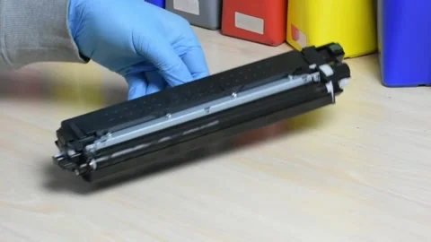 Laser Printer Toner Change Over Wood Desk with Gloved Hand Stock Footage 323075924
