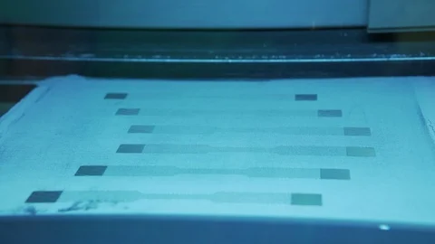 Laser printing a pattern on cloth Stock Footage 99054603