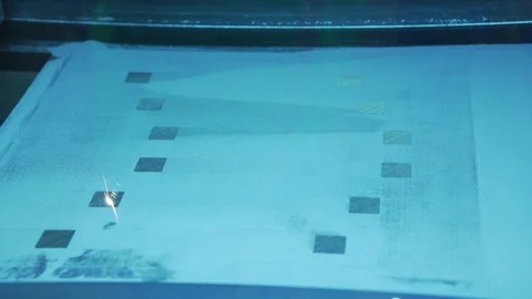 Laser printing a pattern on cloth Stock Footage 99054681
