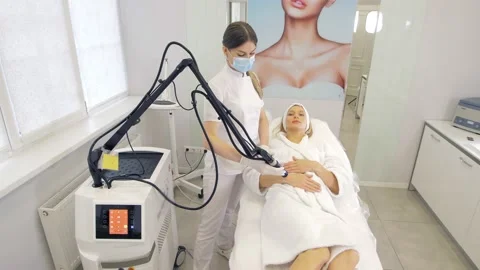 Laser procedure in the clinic.Cosmetologist performs hardware laser hair removal Stock Footage 169077269
