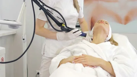 Laser procedure in the clinic.Cosmetologist performs hardware laser hair removal Stock Footage 169517990