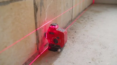 Laser red rays creating horizontal crosshair for accurate measures on Stock Footage 147543864
