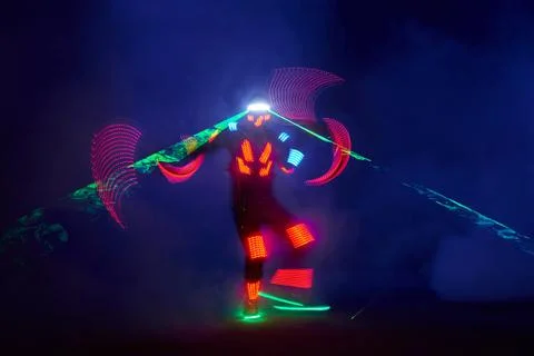 Laser show performance, dancers in led suits with LED lamp, very beautiful ni Stock Photos