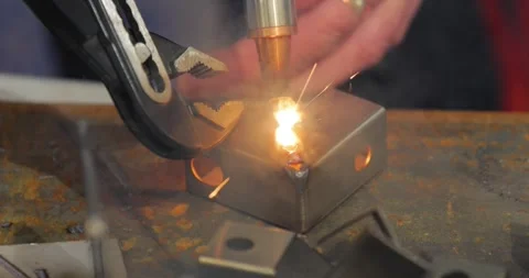 Laser welding machine with hand hold gun. Laser welding is shown in close-up. Stock Footage 249891135