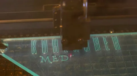 A lasercutter cutting a logo on plexiglas Stock-Footage 55968313