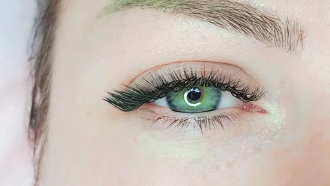 Lash extensions in beauty salon macro eye top view Stock Footage 254436912