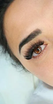 Lash extensions in beauty salon macro eye top view Stock Photos