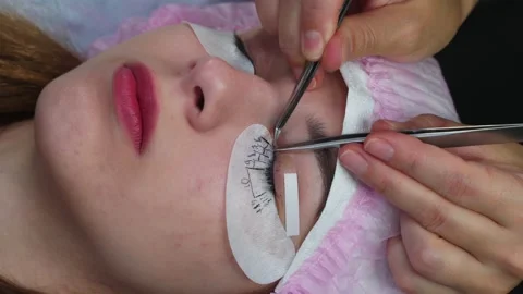 Lash Maker close-up eyelash extension. 4k Stock Footage 140712020