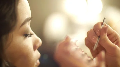 Lash maker increases eyelashes, make up artist making long lashes, woman in Stock Footage 75040330