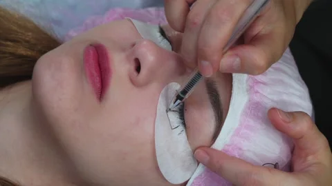 Lash Maker prepares the client's eyelashes for extension procedure Stock Footage 140711708