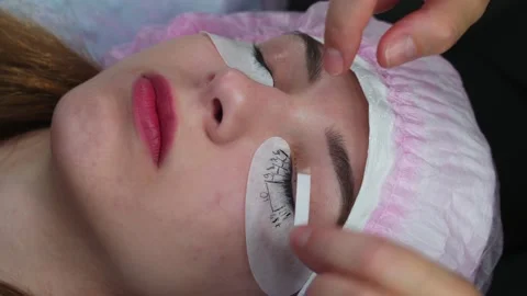 Lash Maker prepares the client's eyelashes for extension procedure Stock Footage 140711838