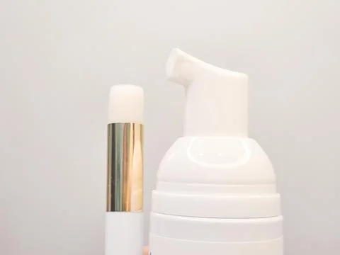 Lash shampoo bottle and applicator with sleek design and modern aesthetic Stock Photos