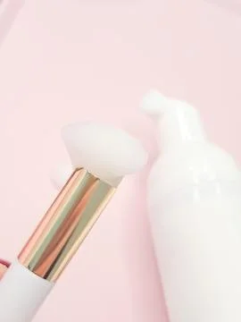 Lash shampoo concept with foam applicator on soft pink background Stock Photos