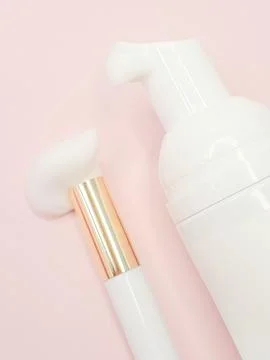 Lash shampoo concept with foamy texture and elegant applicator on pink back.. Stock Photos