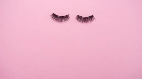 Lashes loss and extension concept. Fake eyelashes on pink background. Makeup. Stock Footage 159857367