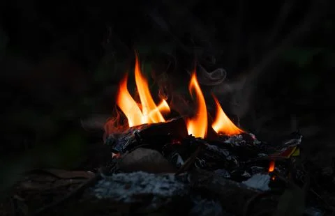 Last bit of flame with smoke in a garbage pit Stock Photos