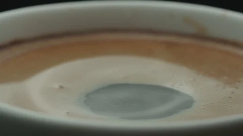 Last drop of espresso falls into the filled Cup from the coffee machine in slow Stock Footage 88389218