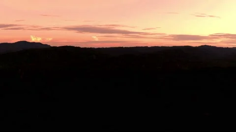Last light is coloring the evening sky with red above a tropical forest Stock Footage 165847795